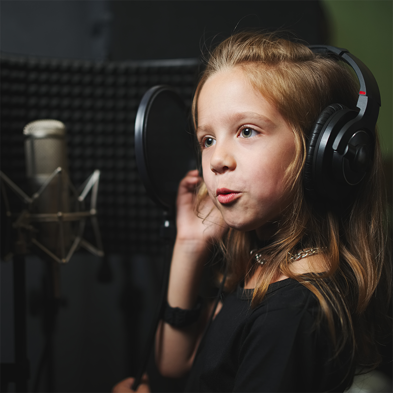 Girl in studio with headphones.